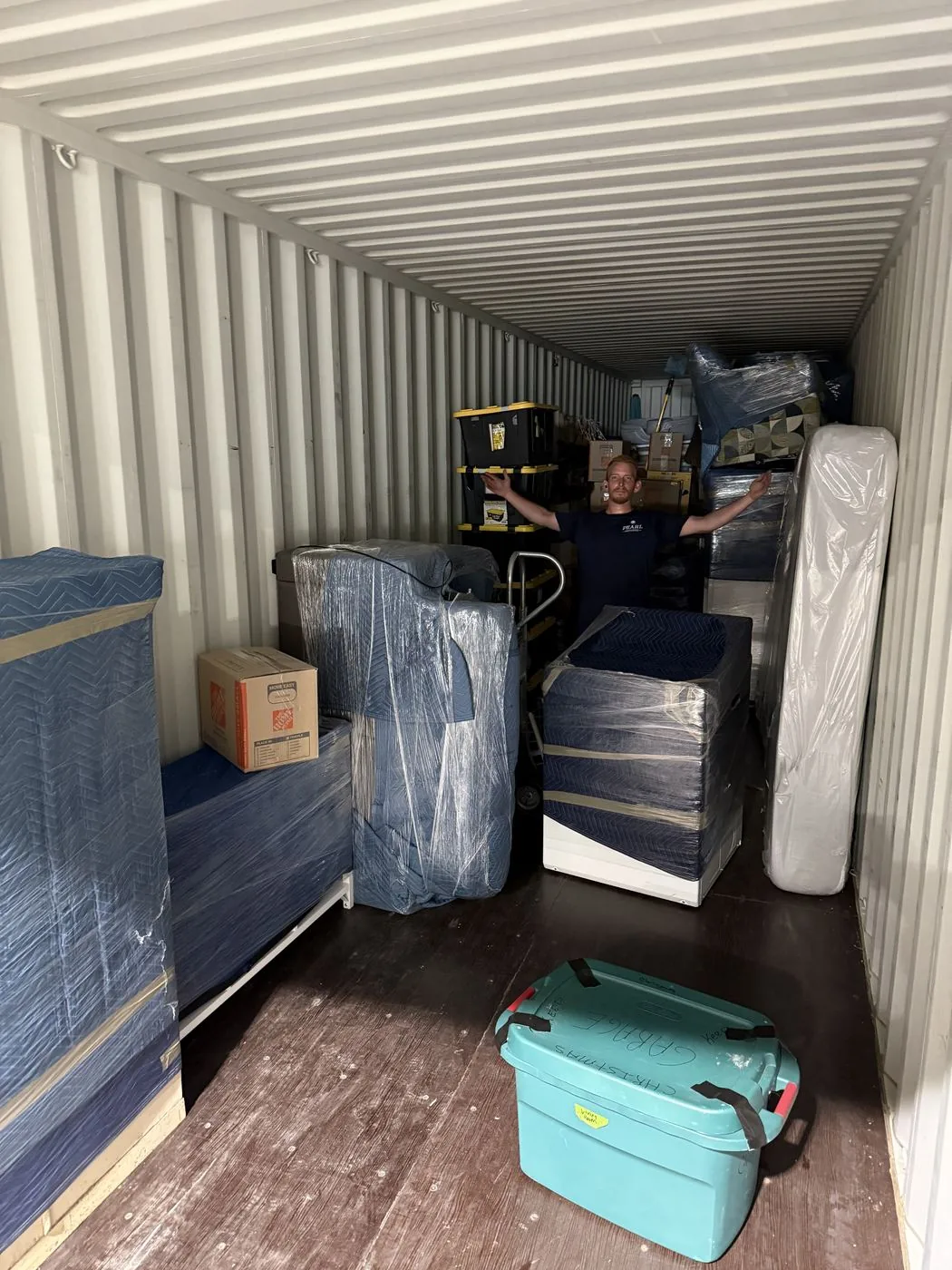 Wrapped furniture packed and secured inside a moving container