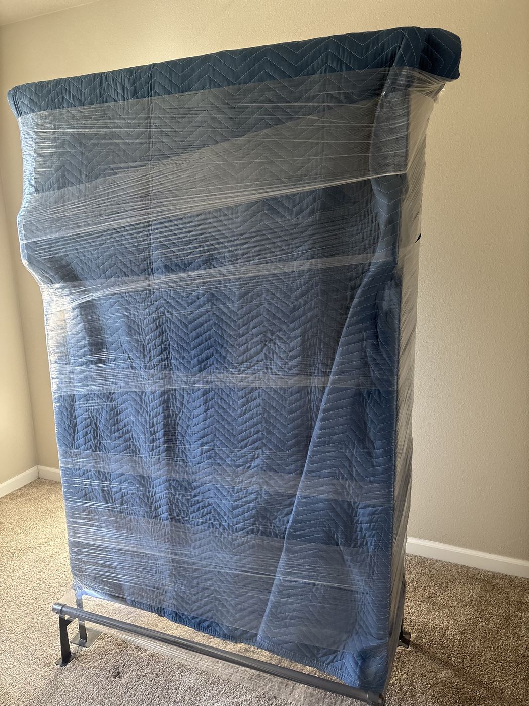 A mattress protected with a moving blanket and shrink wrap by Pearl Movers